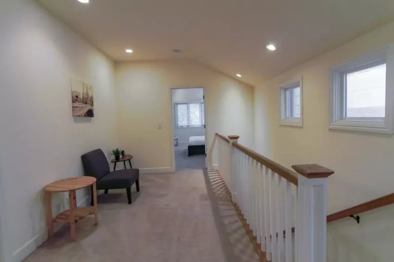 A home with a chair and a window, featuring the benefits of using Master Clean Bay Area for move in/out cleaning.