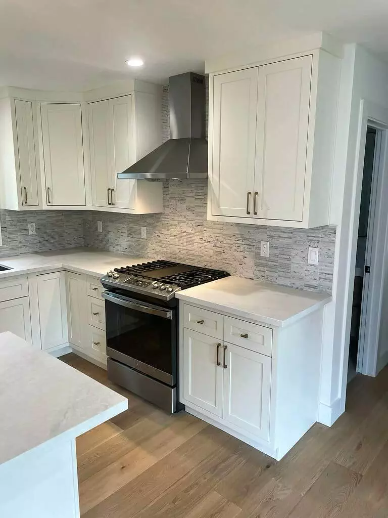 Kitchen, white cabinets, stainless steel appliances.