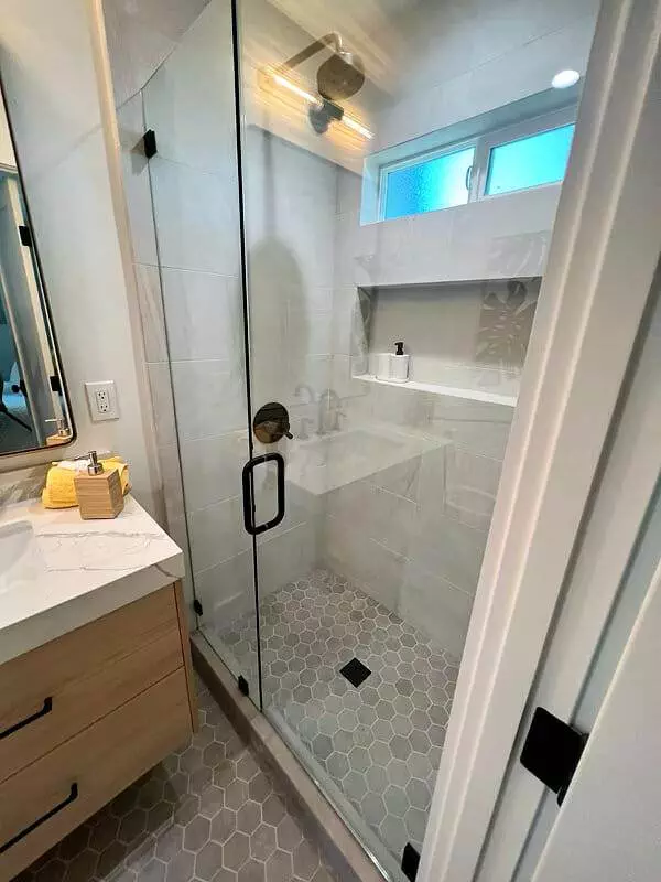 Bathroom with glass shower stall and sink.