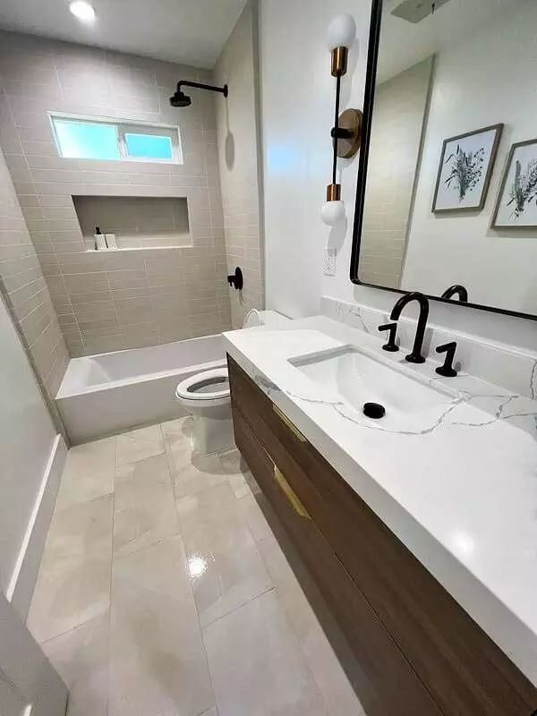 Bathroom with sink, toilet, and mirror.