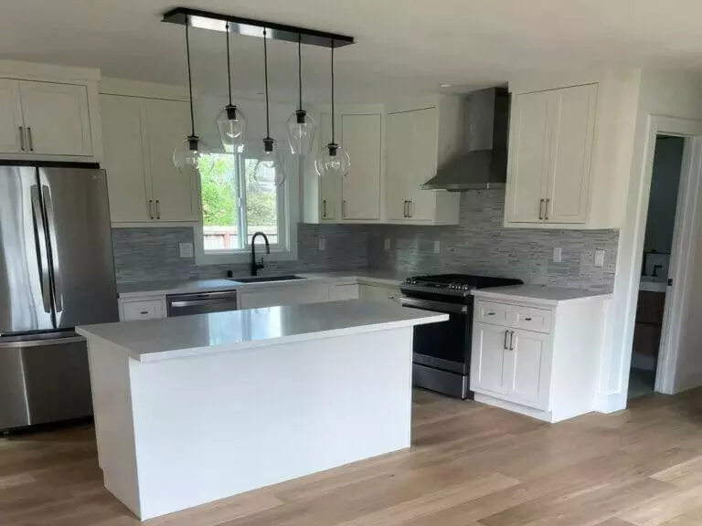 Kitchen, white cabinets, stainless steel appliances.