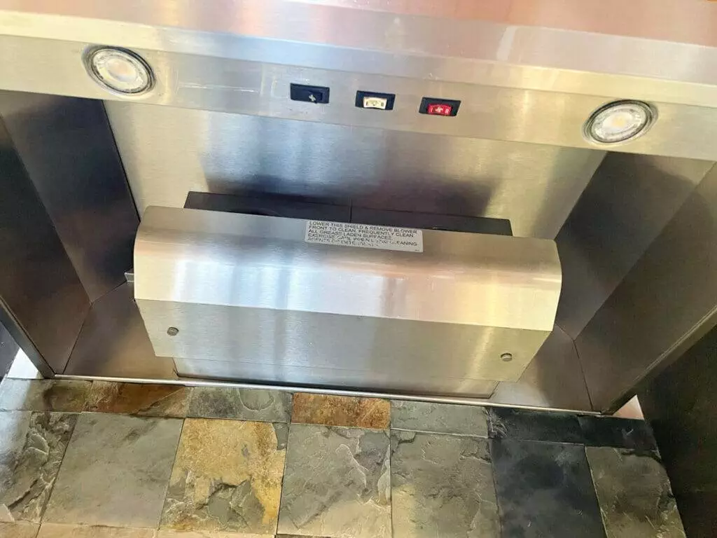A stainless steel ice machine with a clock, perfect for the bay area.