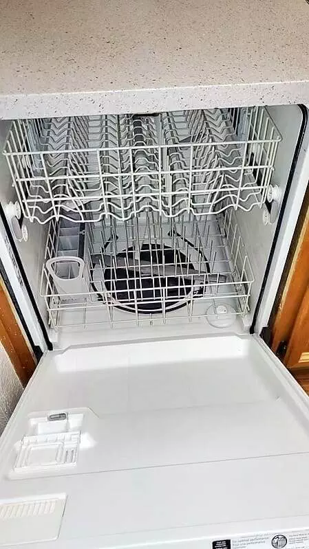 A cupertino kitchen dishwasher with a rack for move in or move out cleaning.