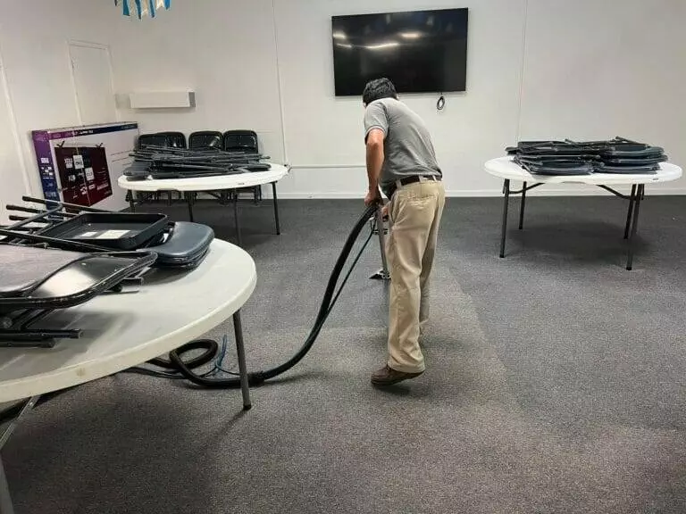 A man tidying up an Auto Draft-filled room.