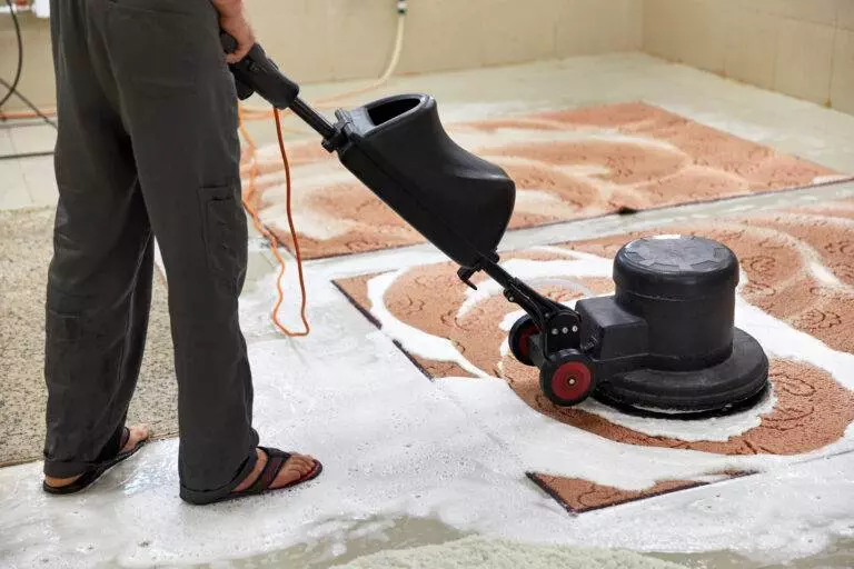 An expert cleaning service in San Jose is cleaning a tile floor in a living space.