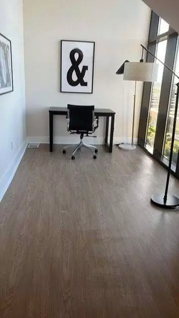 Modern home office with a black desk and chair, large 