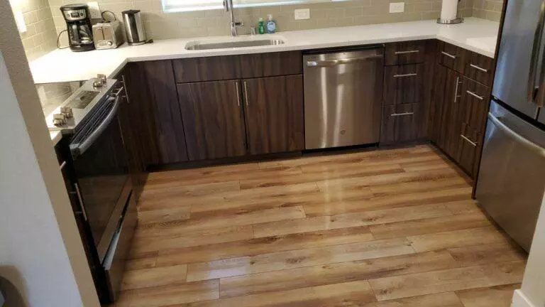 Modern kitchen with dark wood cabinets, stainless steel appliances, and light hardwood flooring, expertly cleaned by Union City Post Construction Cleaning.