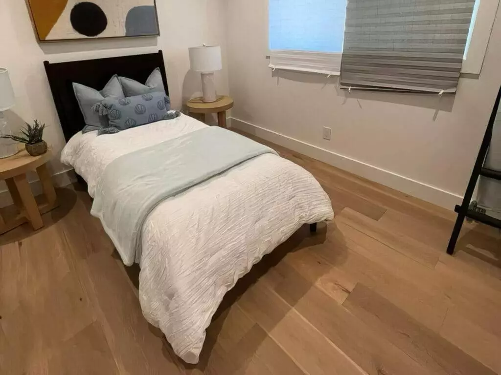Small bedroom, hardwood floors.